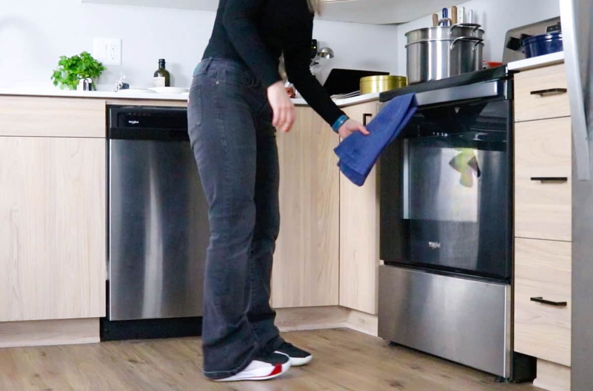 Kristin is drying her hands on a kitchen towel