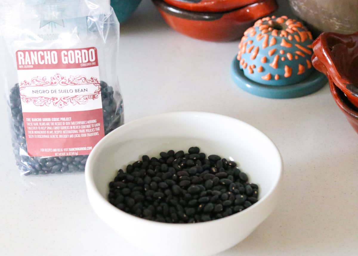 Rancho Gordo Negro de Suelo beans in the package and in a bowl