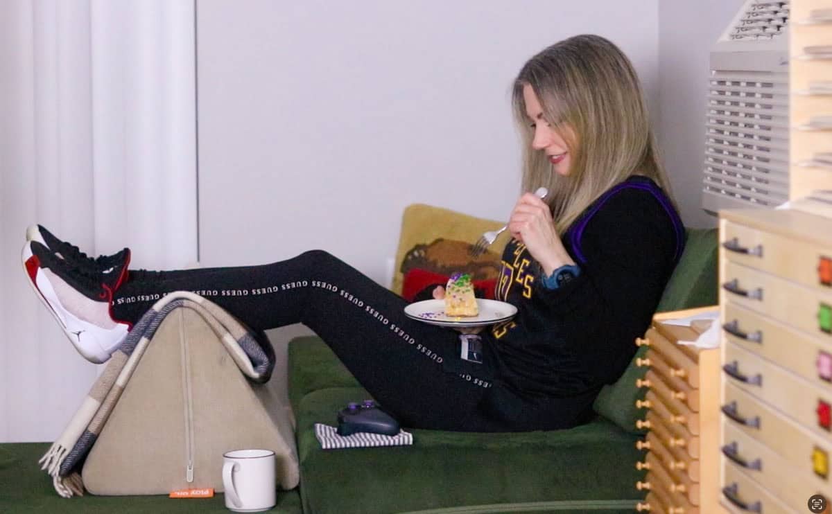 Kristin is watching the game and eating King Cake