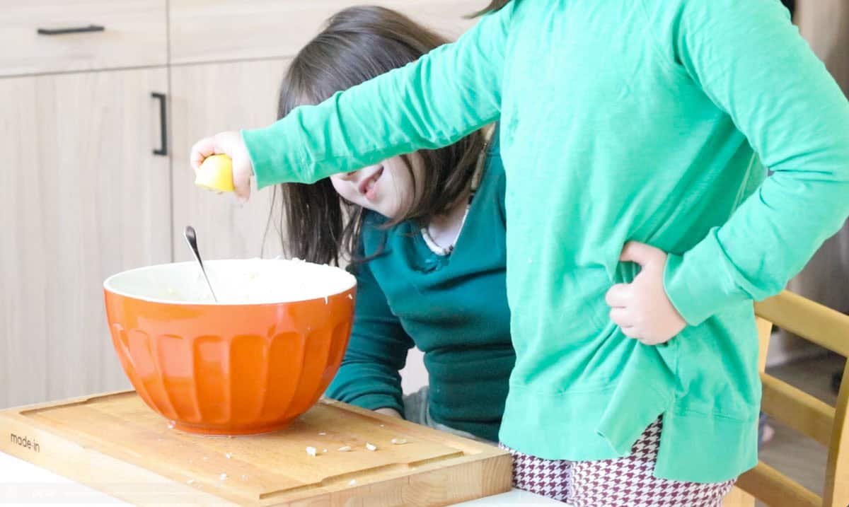 Katalina is squeezing lemon over a bowl of egg salad