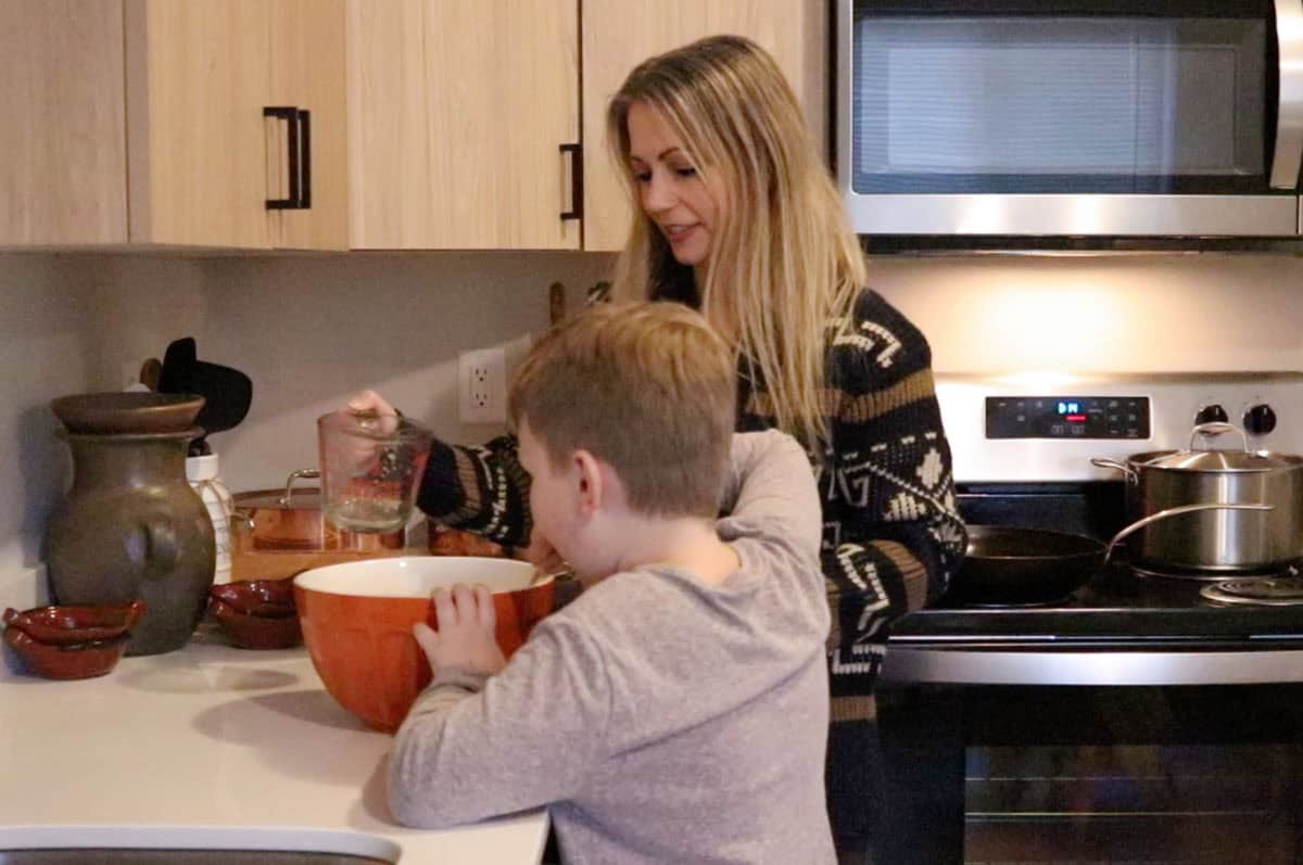 Kristin is adding boiling water to the cornmeal mixture