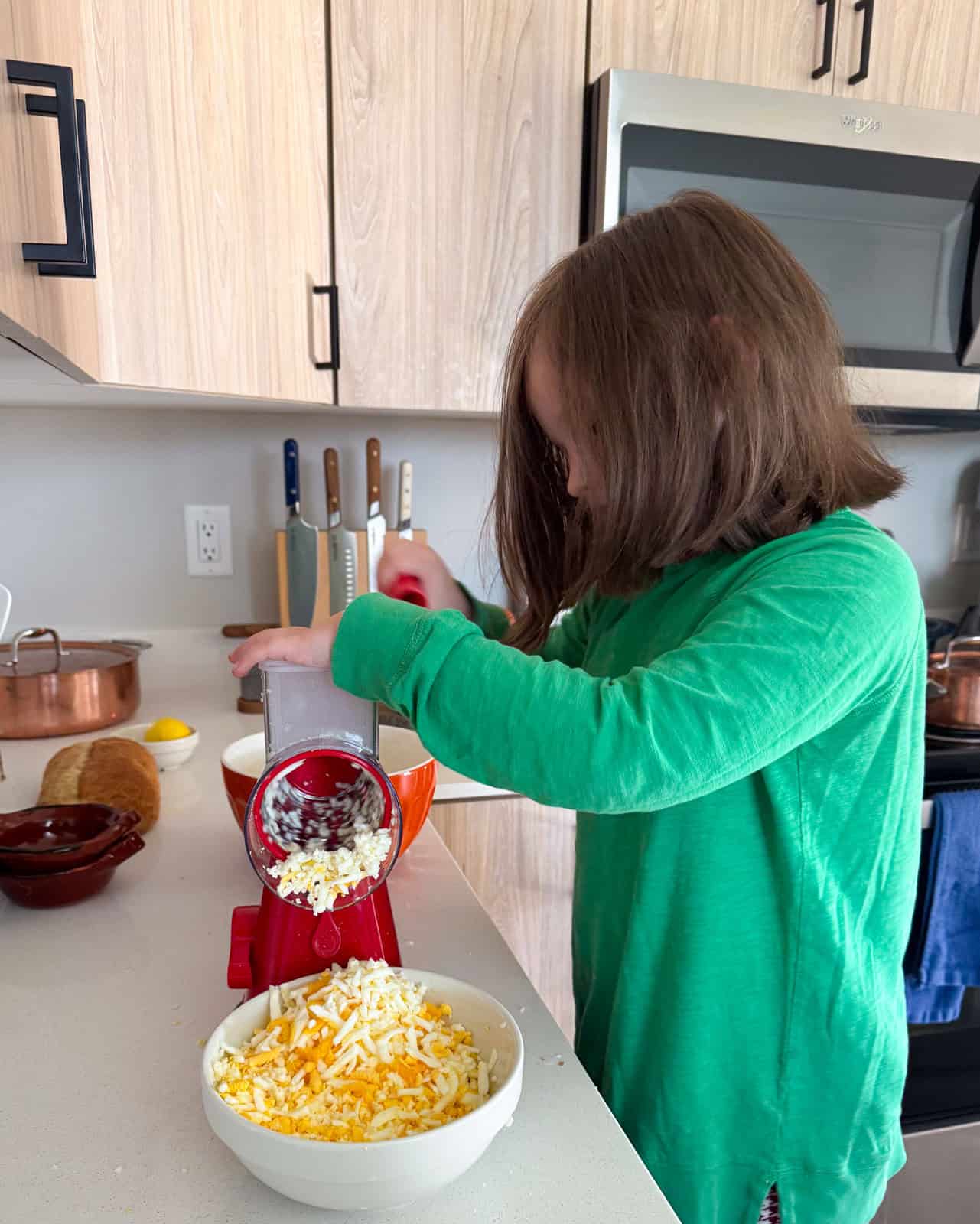 Katalina is grating hard-boiled eggs