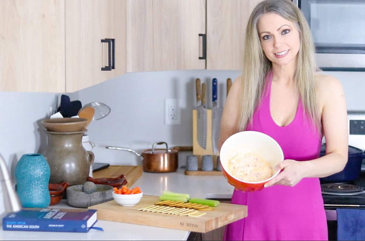 Kristin is showing pimento cheese to the camera