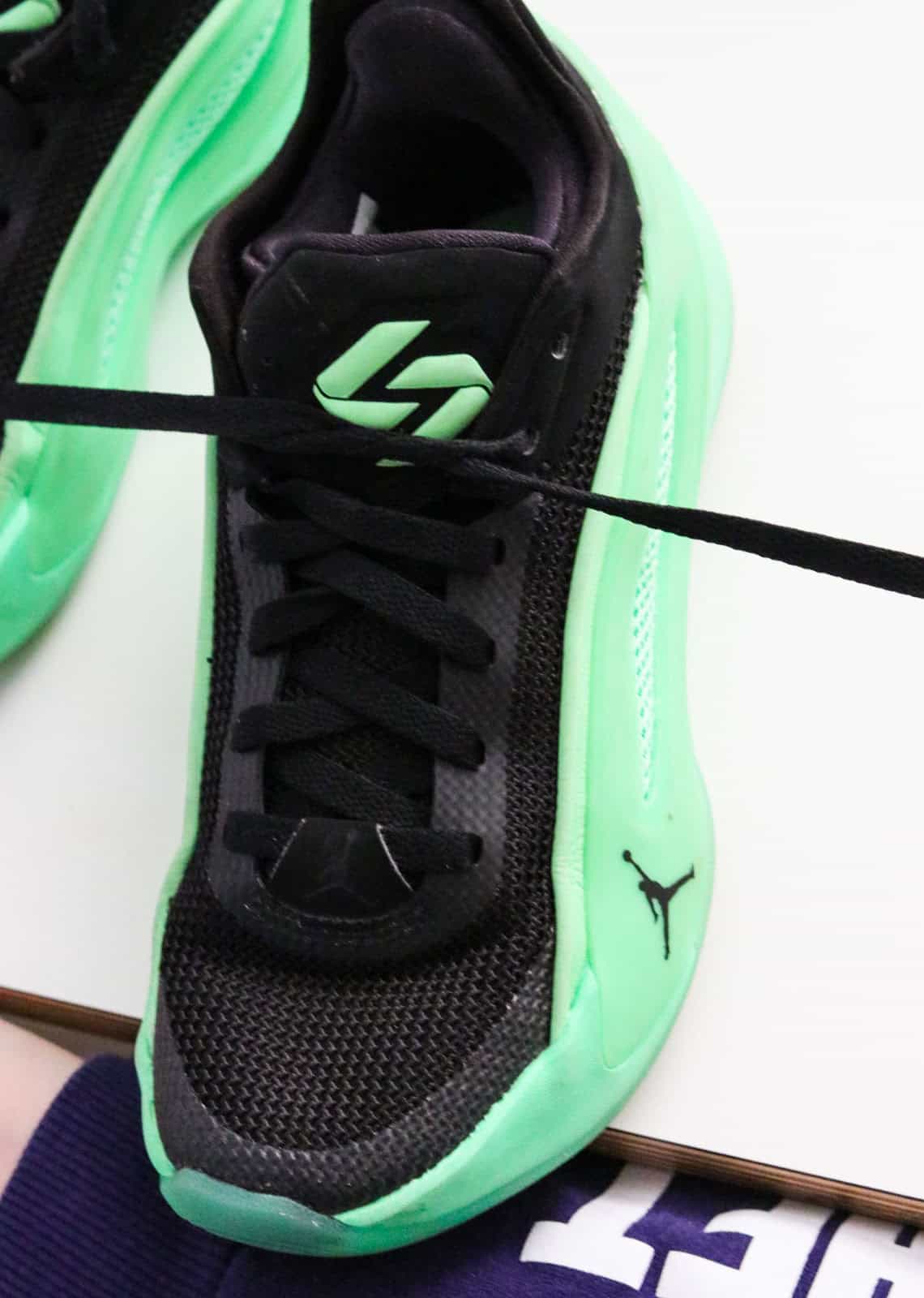 Noah is pulling on the crossed laces