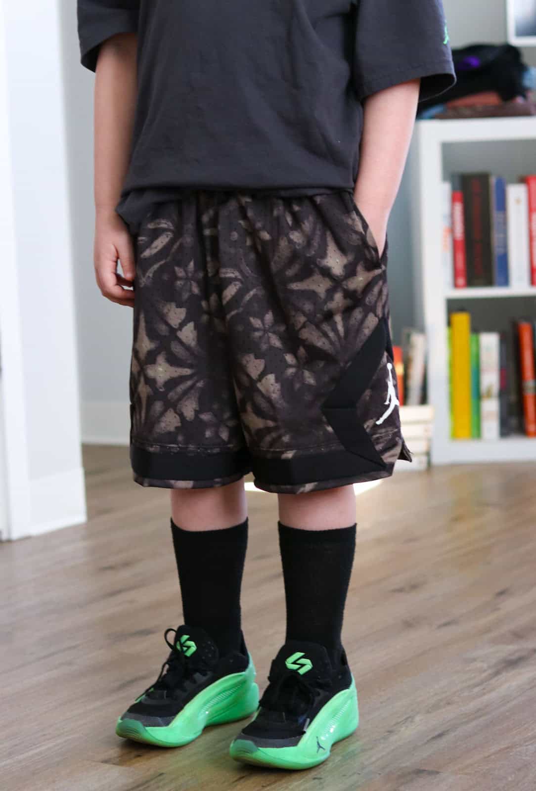 Noah is wearing Luka Dončić Dri-FIT Diamond shorts and Luka 5 Venoms on his feet with tied shoelaces