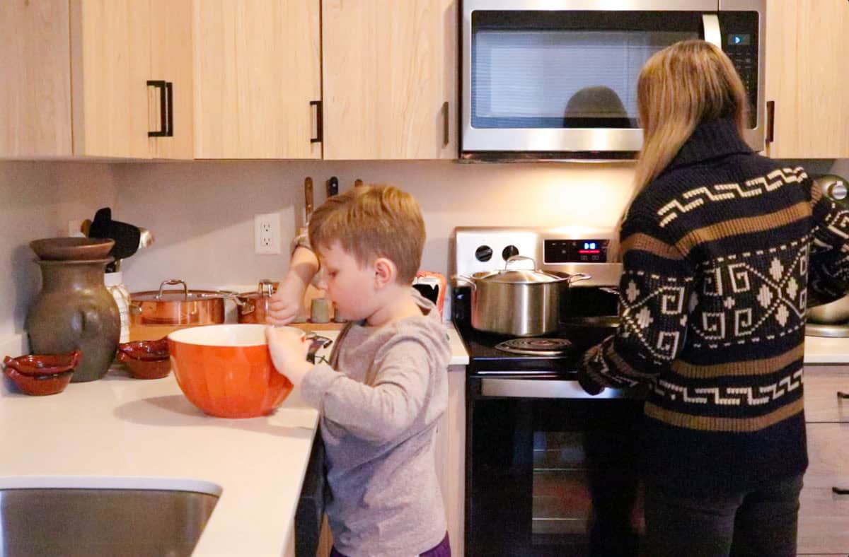 Noah is combining ingredients for hoecakes