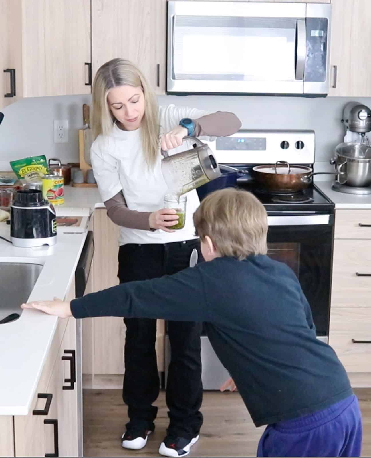 Kristin is pouring nori sauce into a mason jar