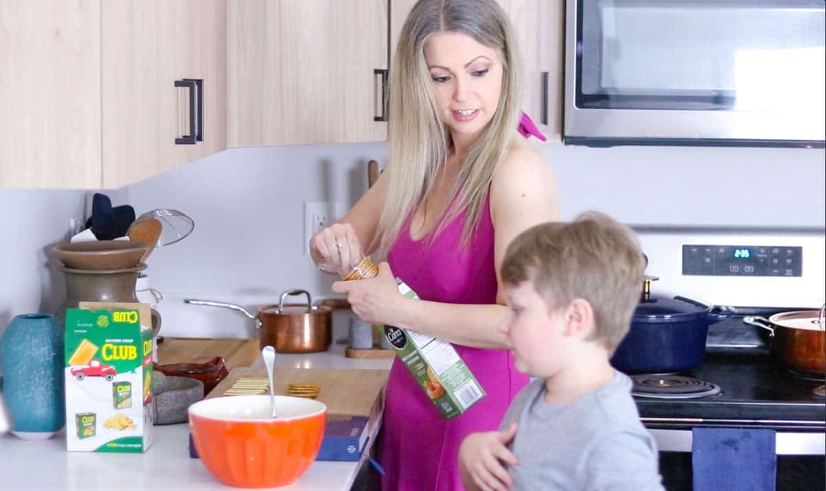 Kristin is opening a package of crackers