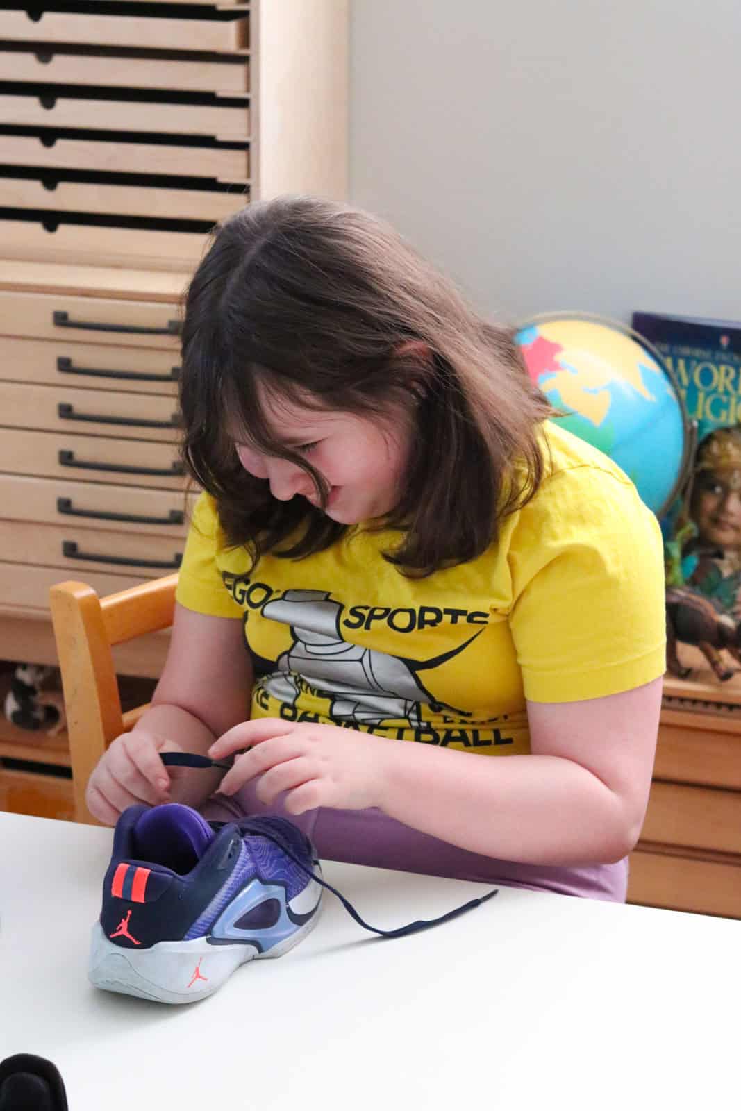 Kaia is smiling and tying Jordan Luka 3 Purple Comet sneakers