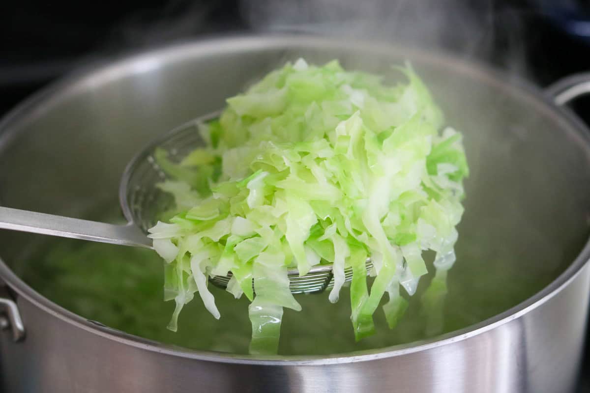 cooked cabbage in a spider strainer