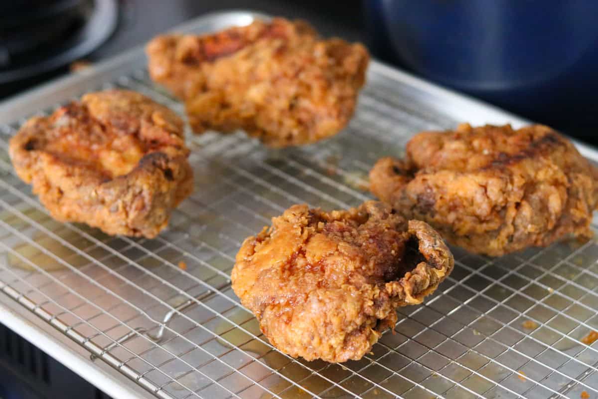 fried chicken thighs on a wire rack