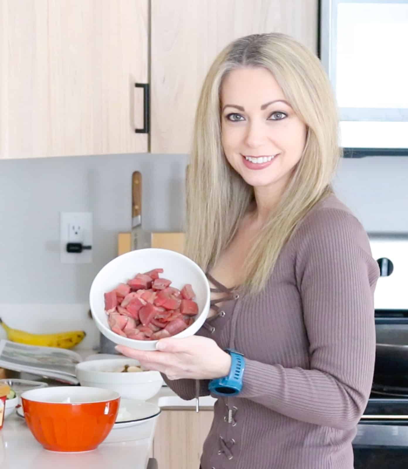 Kristin is holding a bowl with sliced beef shoulder