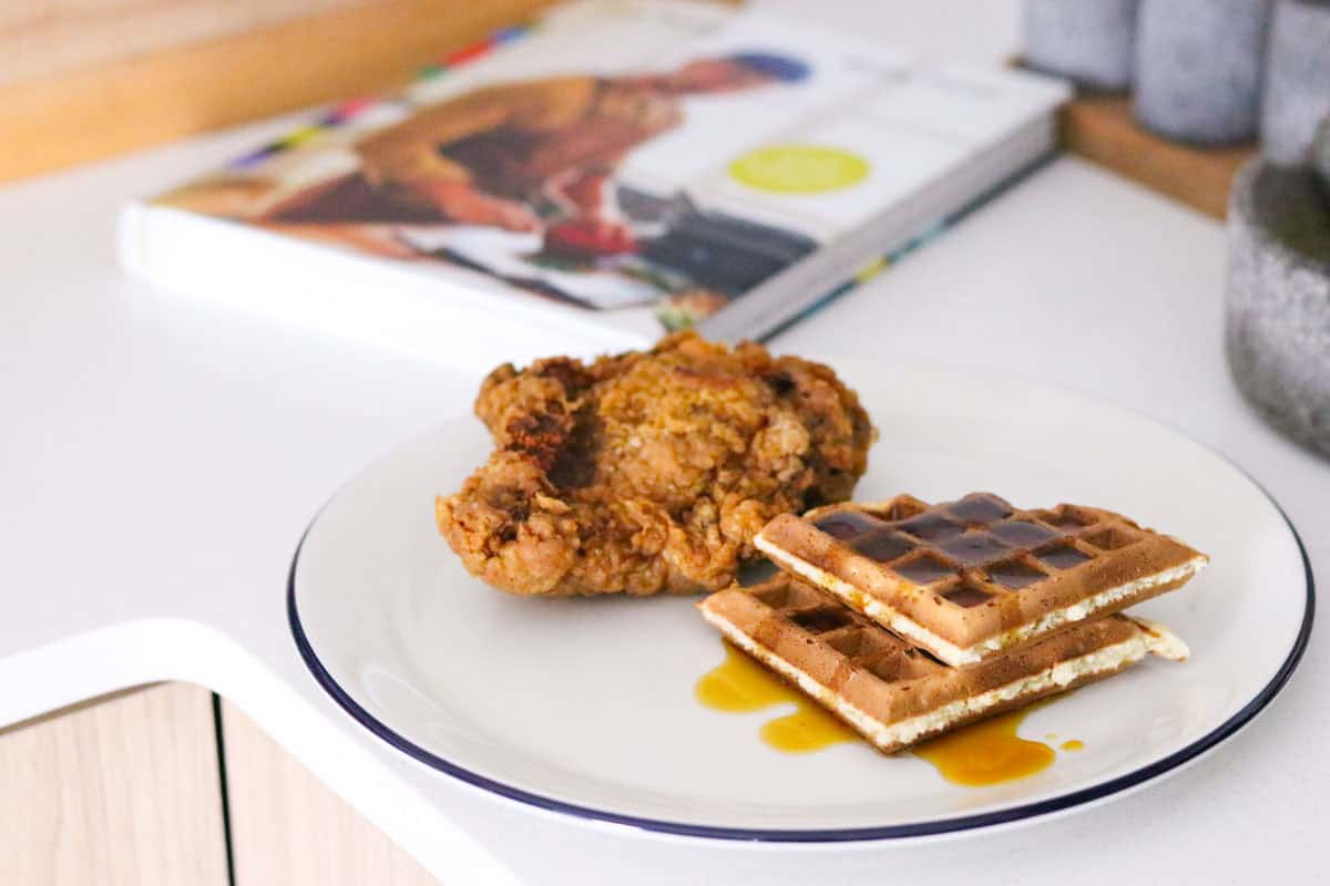 Hong Kong Chicken and Waffles plated beside Kung Food cookbook