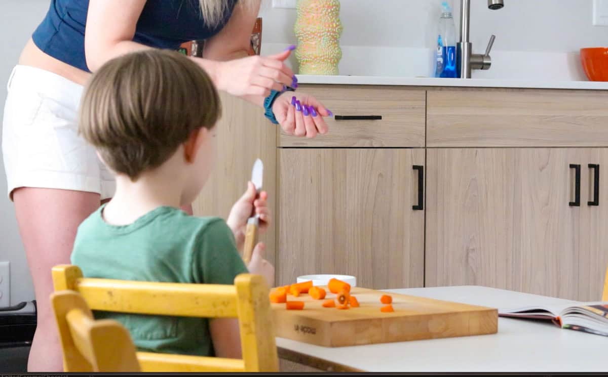 John is slicing carrots with a utility knife