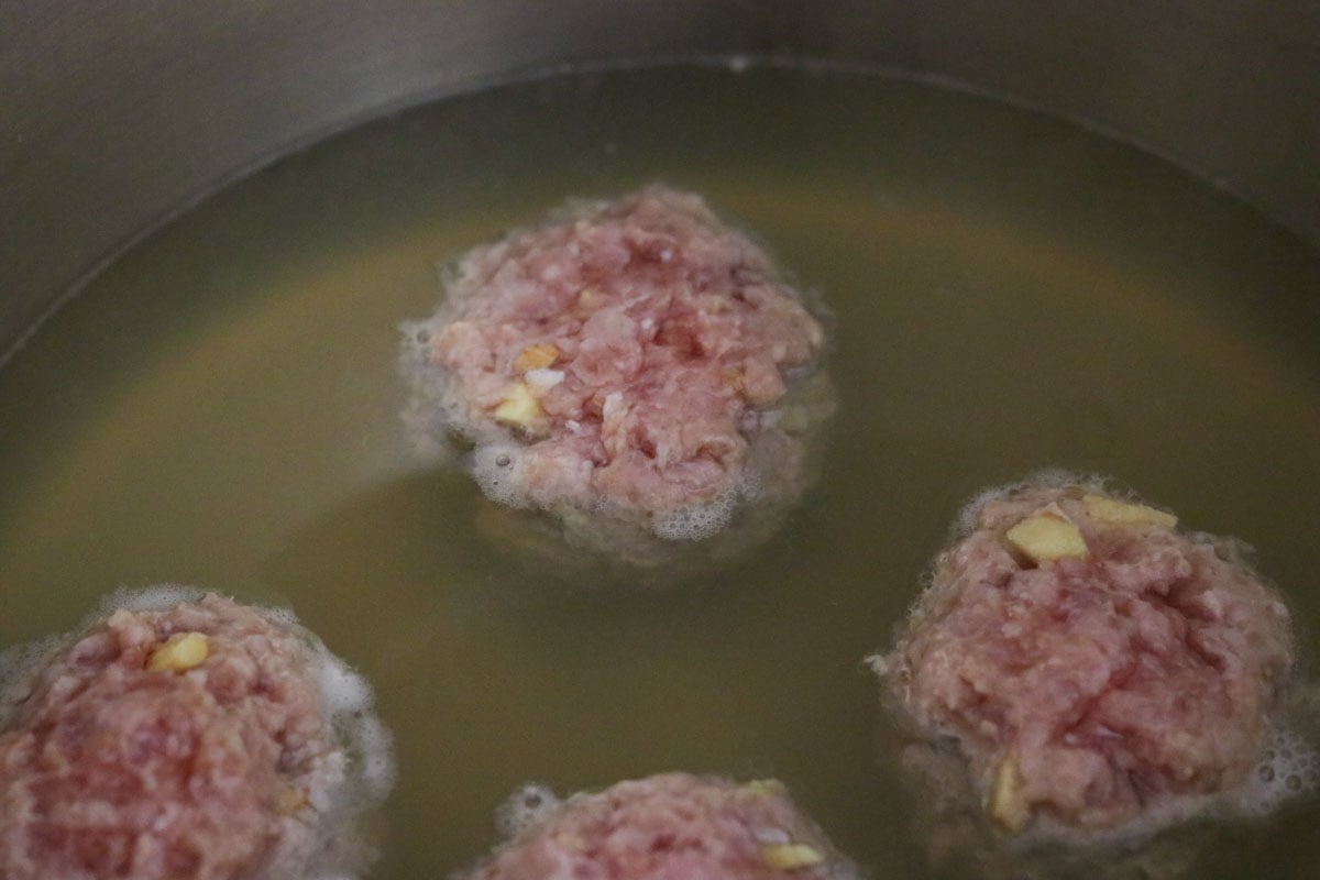 meatballs cooking in stock