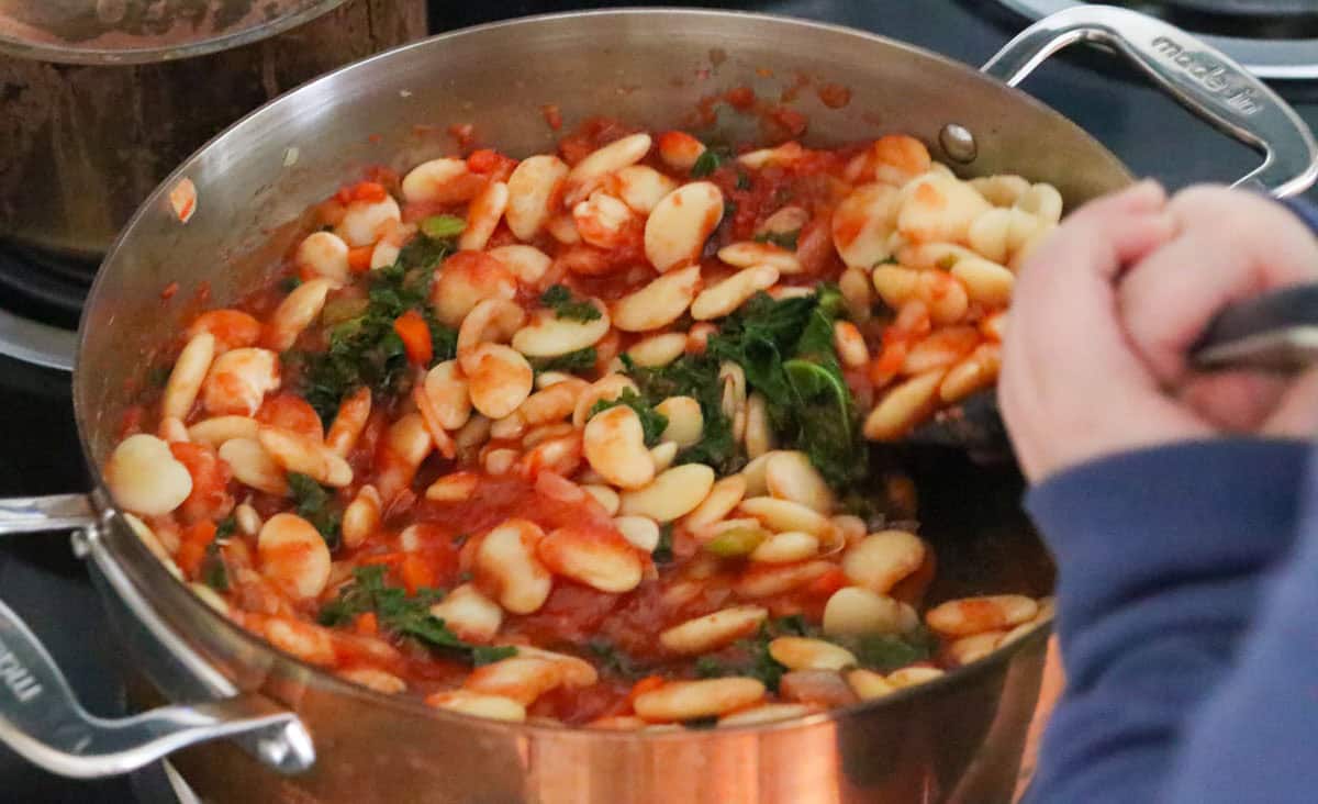 Katalina is stirring pizza beans