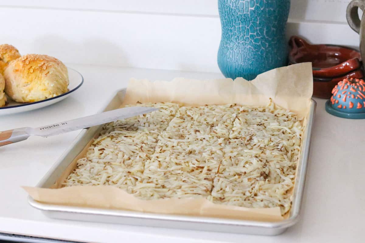 uncooked hashbrowns on a baking sheet