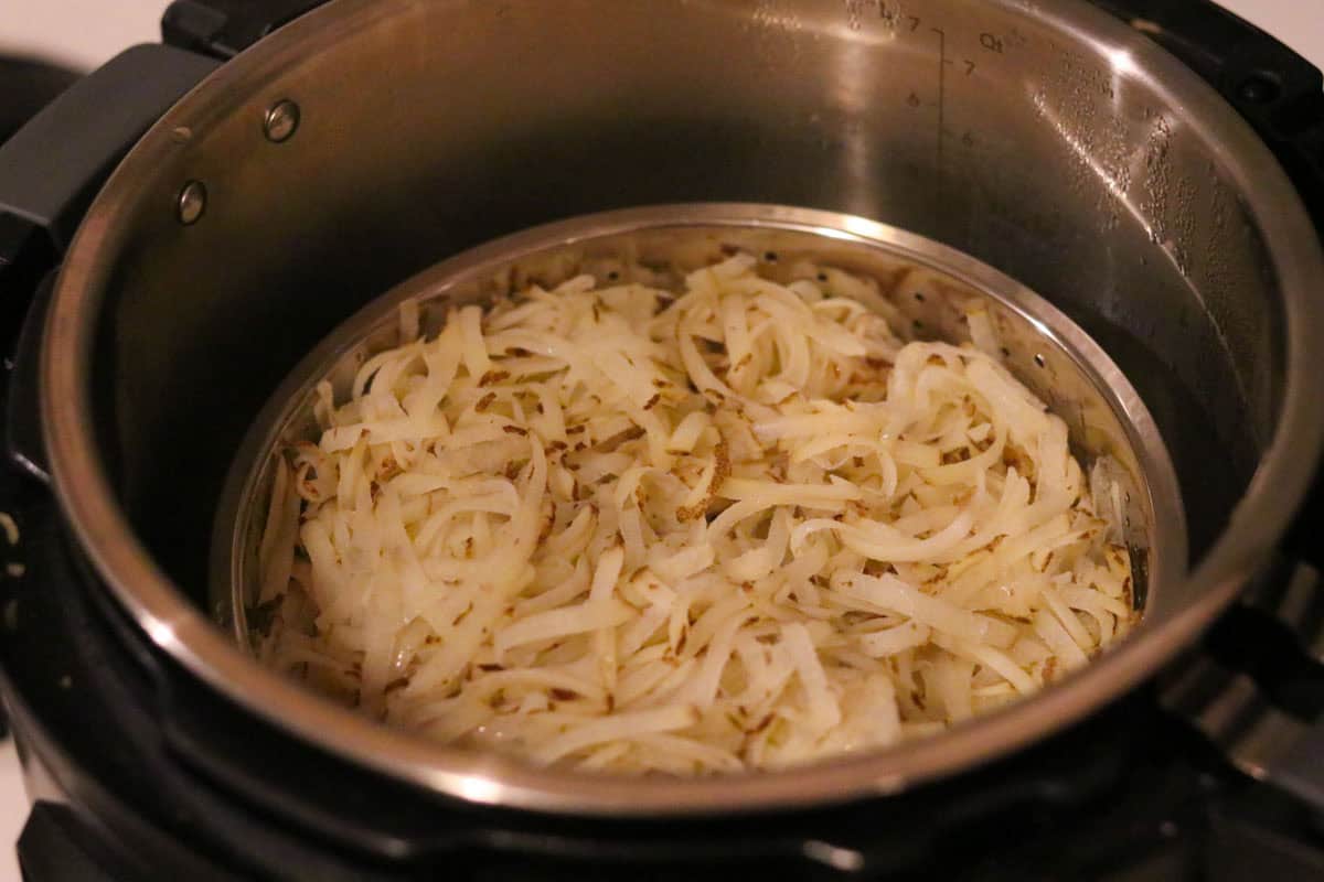 shredded potatoes in a steamer insert of an InstantPot