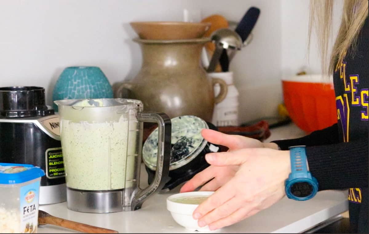 Kristin is holding a bowl of yogurt sauce