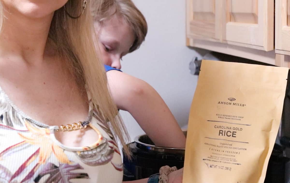 Noah is making Carolina Gold Rice and Kristin is holding a bag of Anson Mills Carolina Gold Rice