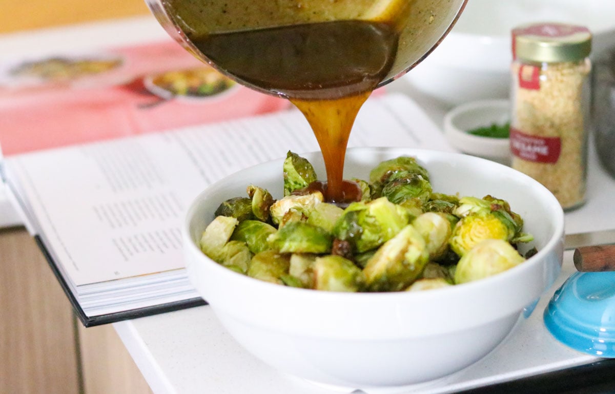 sweet and sticky sauce pouring over Brussels sprouts