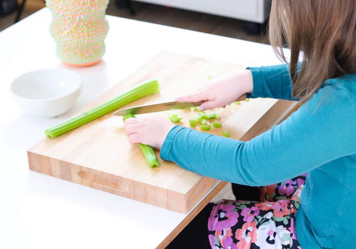 Kat is chopping celery with a utility knife
