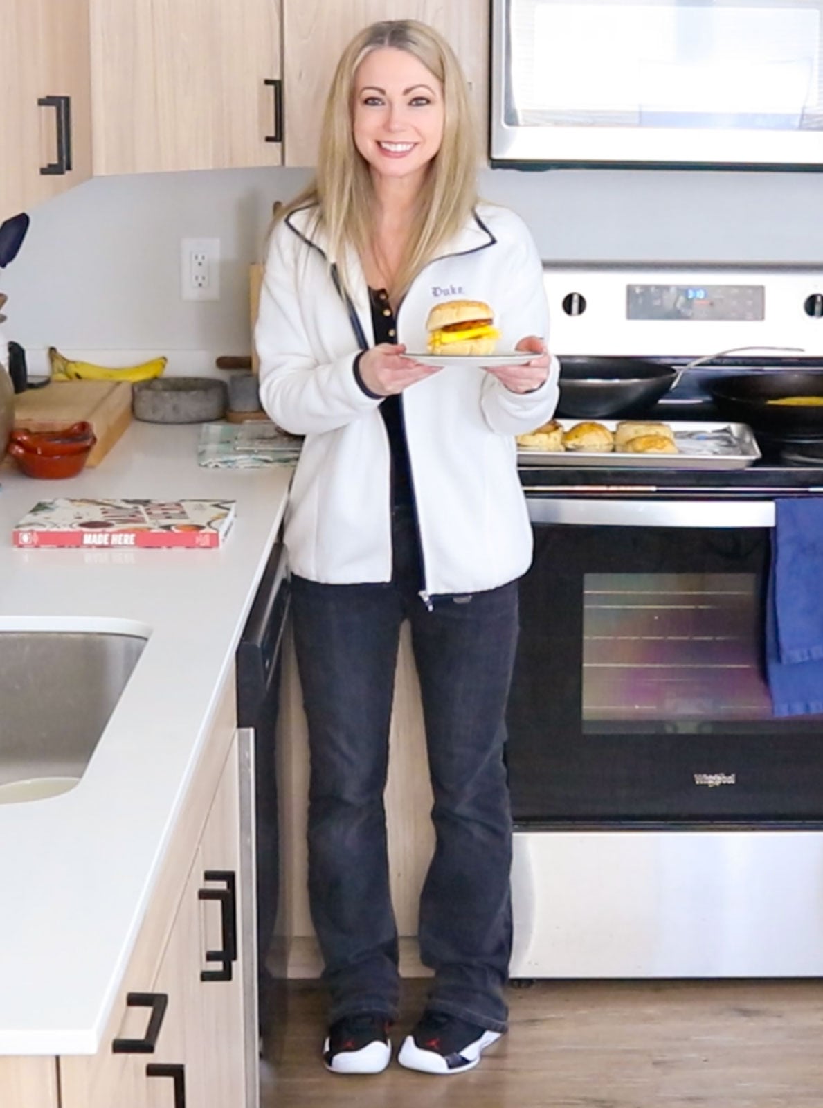 Kristin is holding a plate with a Chinatown breakfast sando