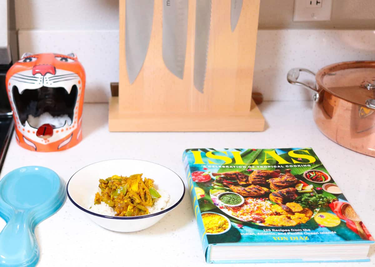 Vindaye Poisson beside Islas cookbook