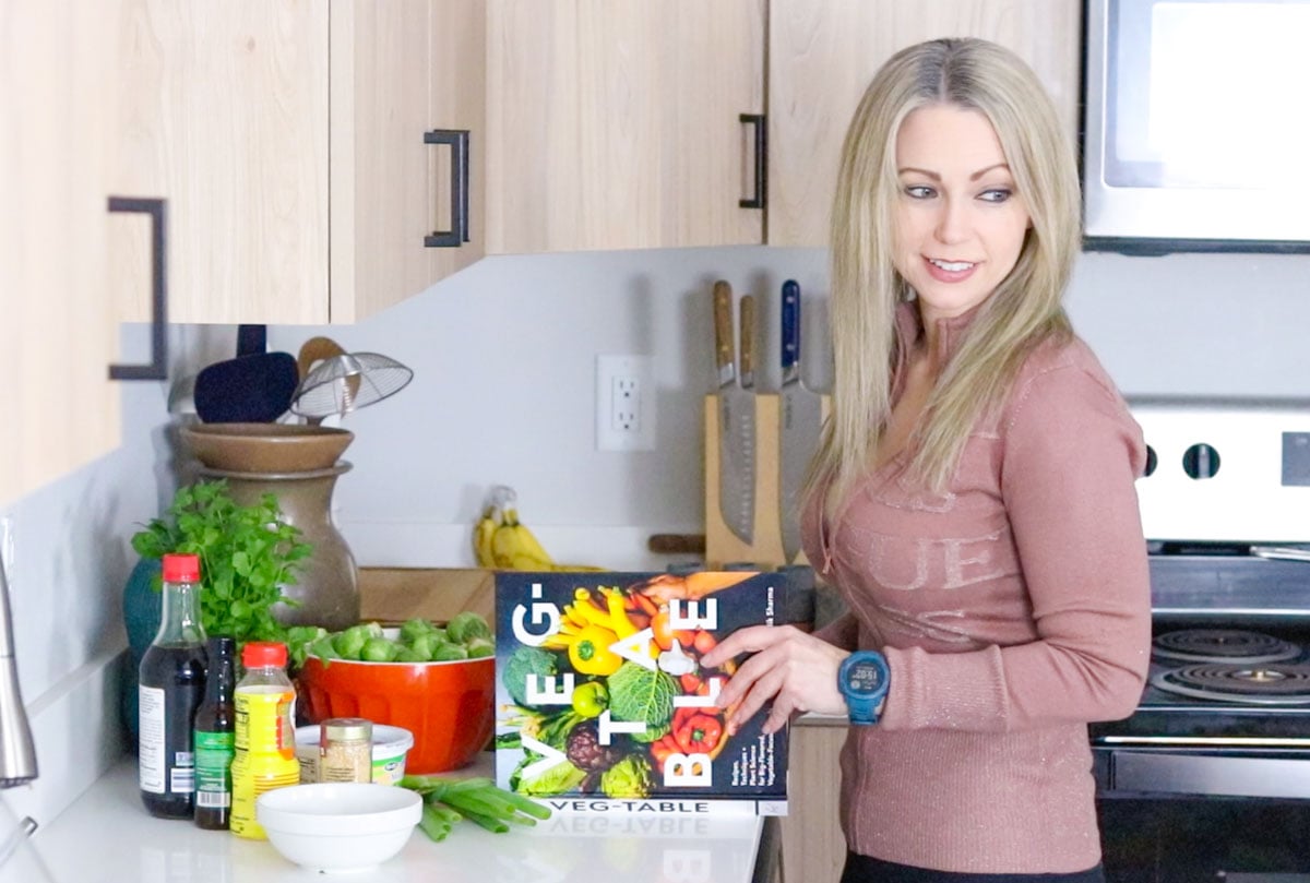 Kristin is watching the kids while opening veg-table cookbook