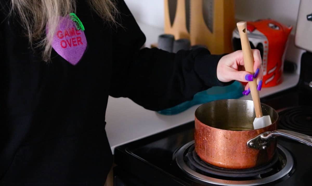 Kristin is stirring chicken teriyaki marinade with a spatula