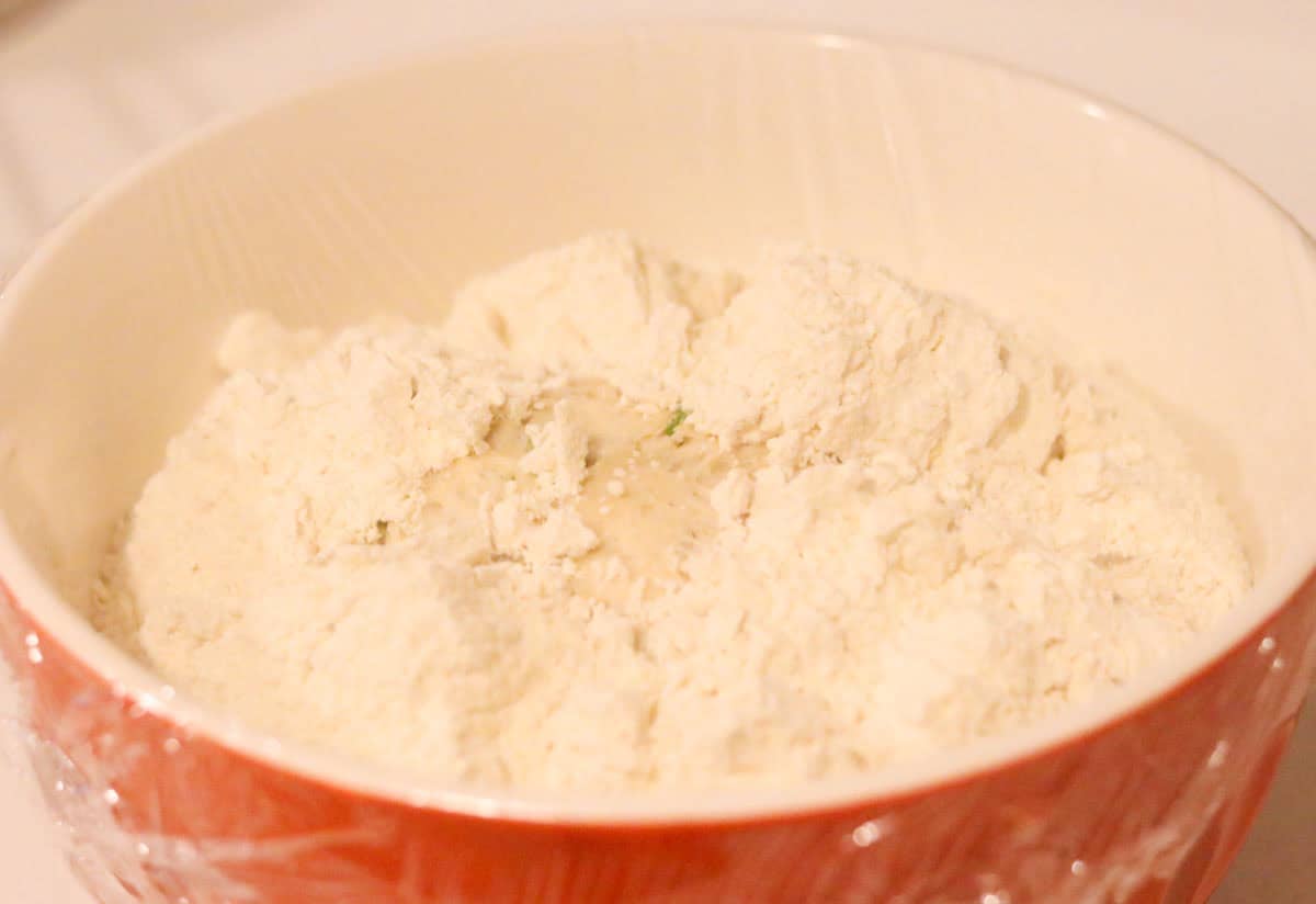 milk buns dough covered with plastic wrap