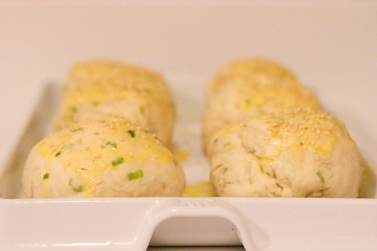 milk buns with egg wash in a baking slab