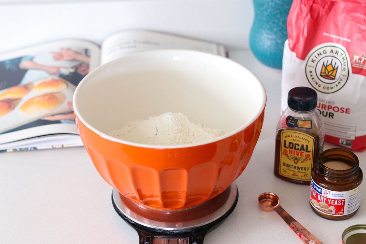 flour, yeast, honey, measuring spoon, and Made Here cookbook