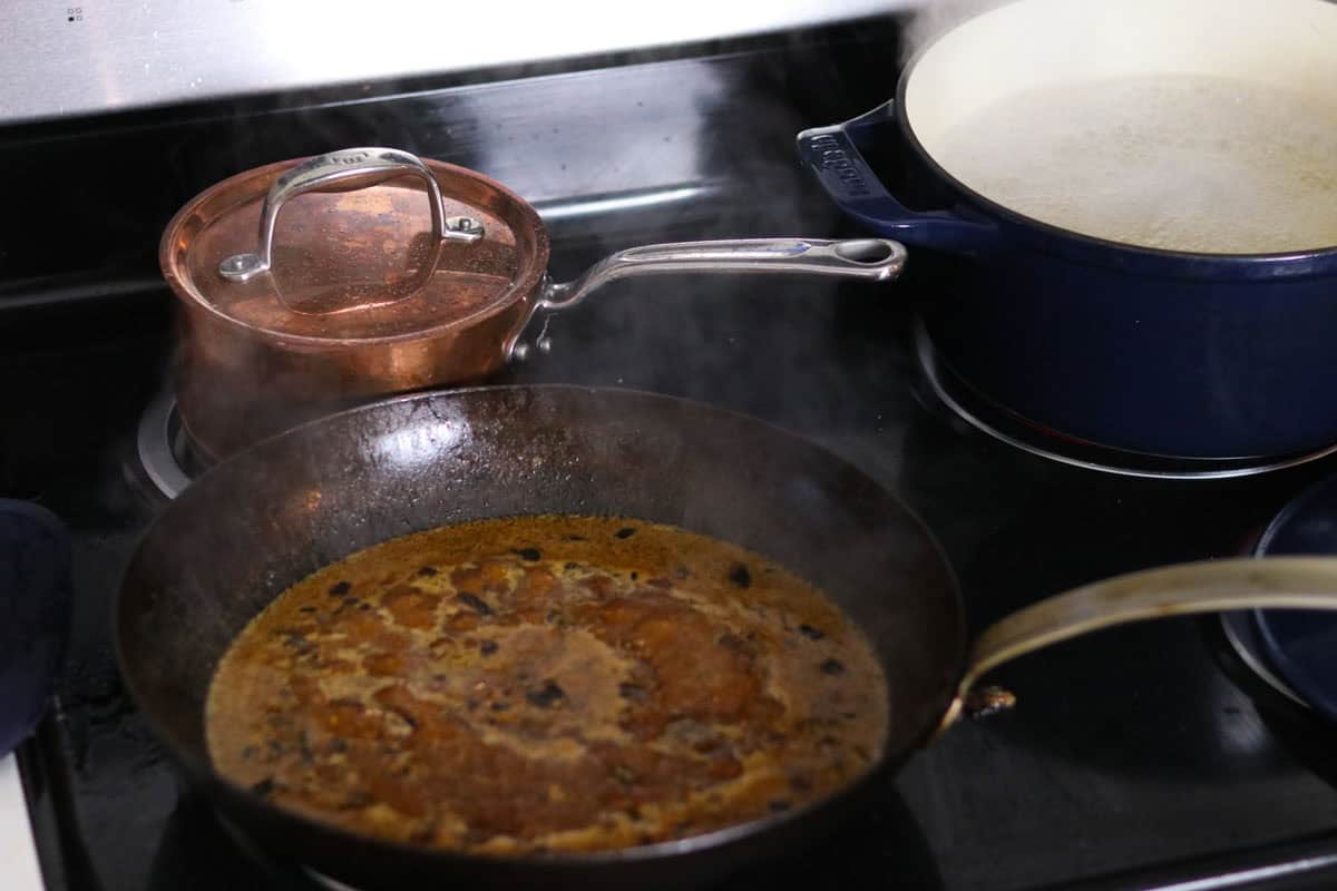 mustard-mushroom sauce for chicken thighs in a carbon steel pan