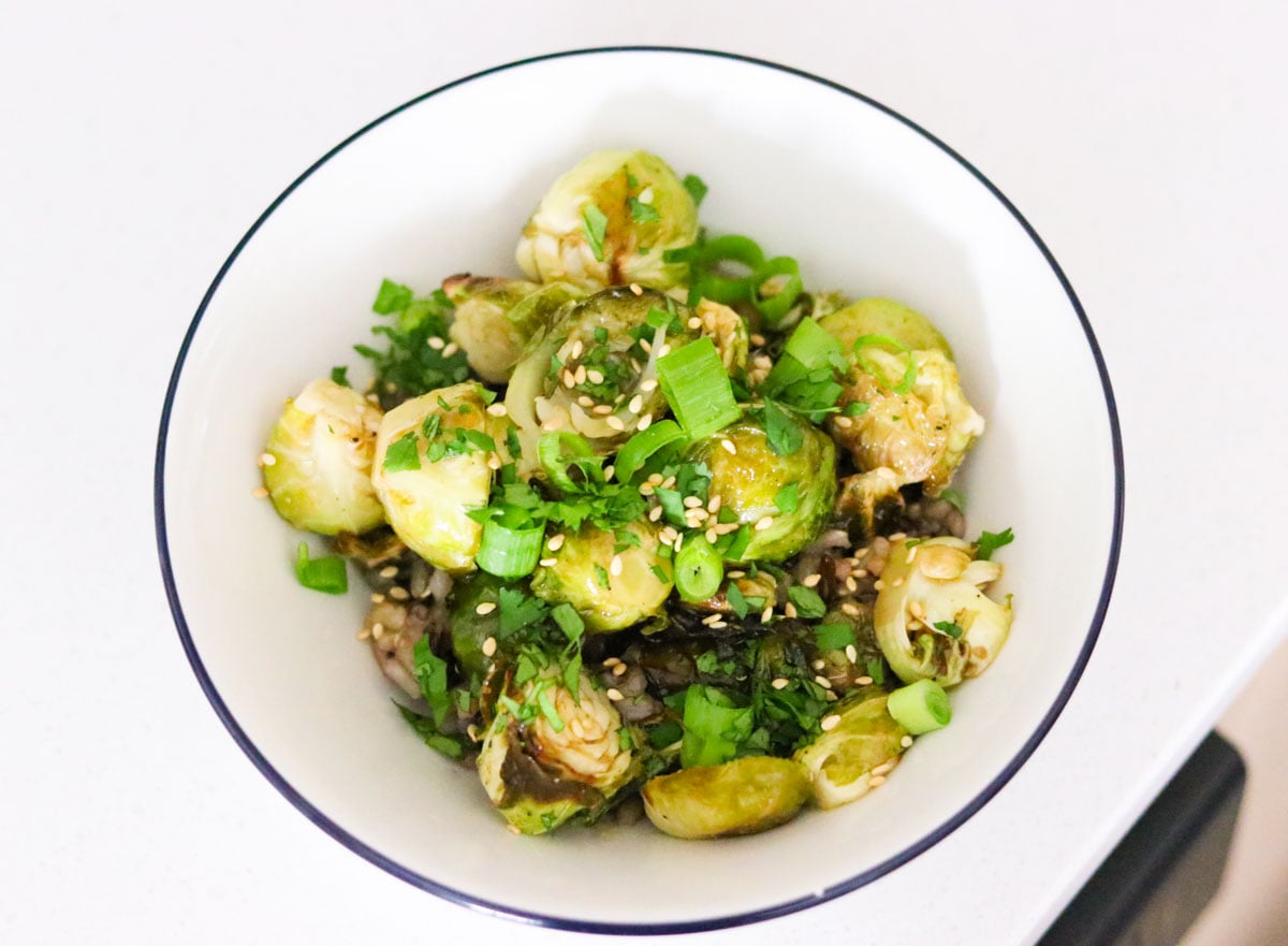 sweet and sticky brussels sprouts in a bowl with wild rice