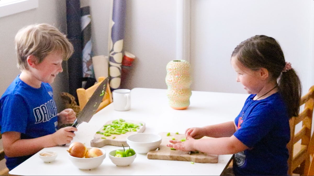 Noah and Kat are prepping vegetables for vindaye poisson