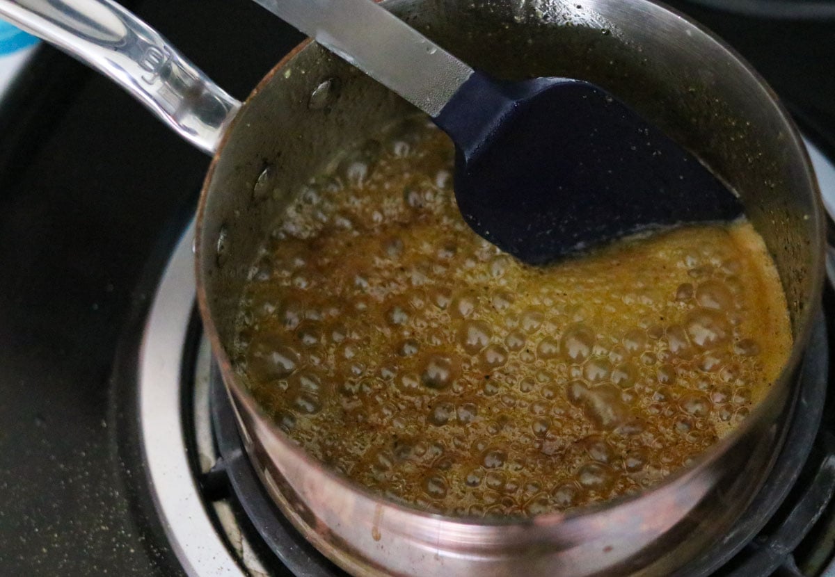 brussels sprouts sauce boiling in a small saucepan