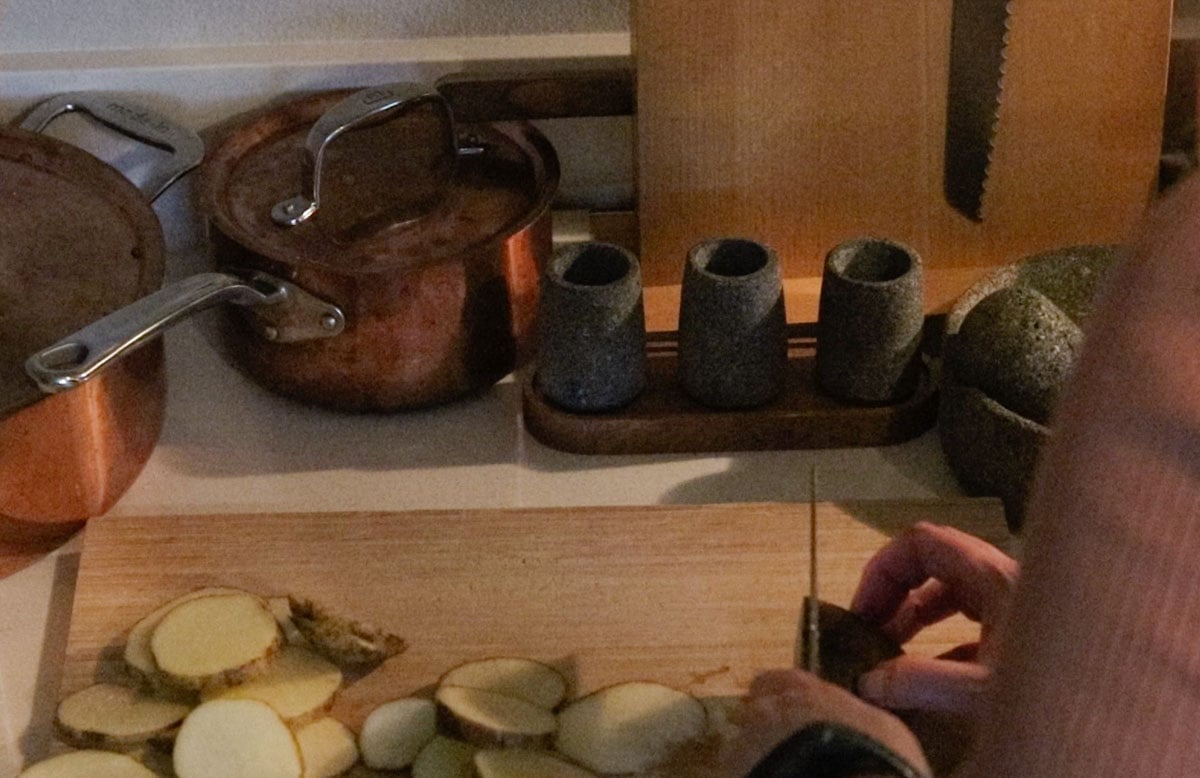 Kristin is slicing potatoes