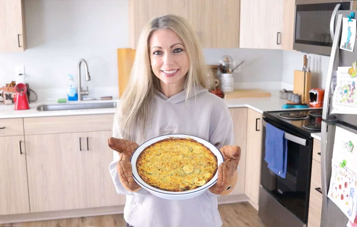 Kristin is showing a zucchini casserole to the camera