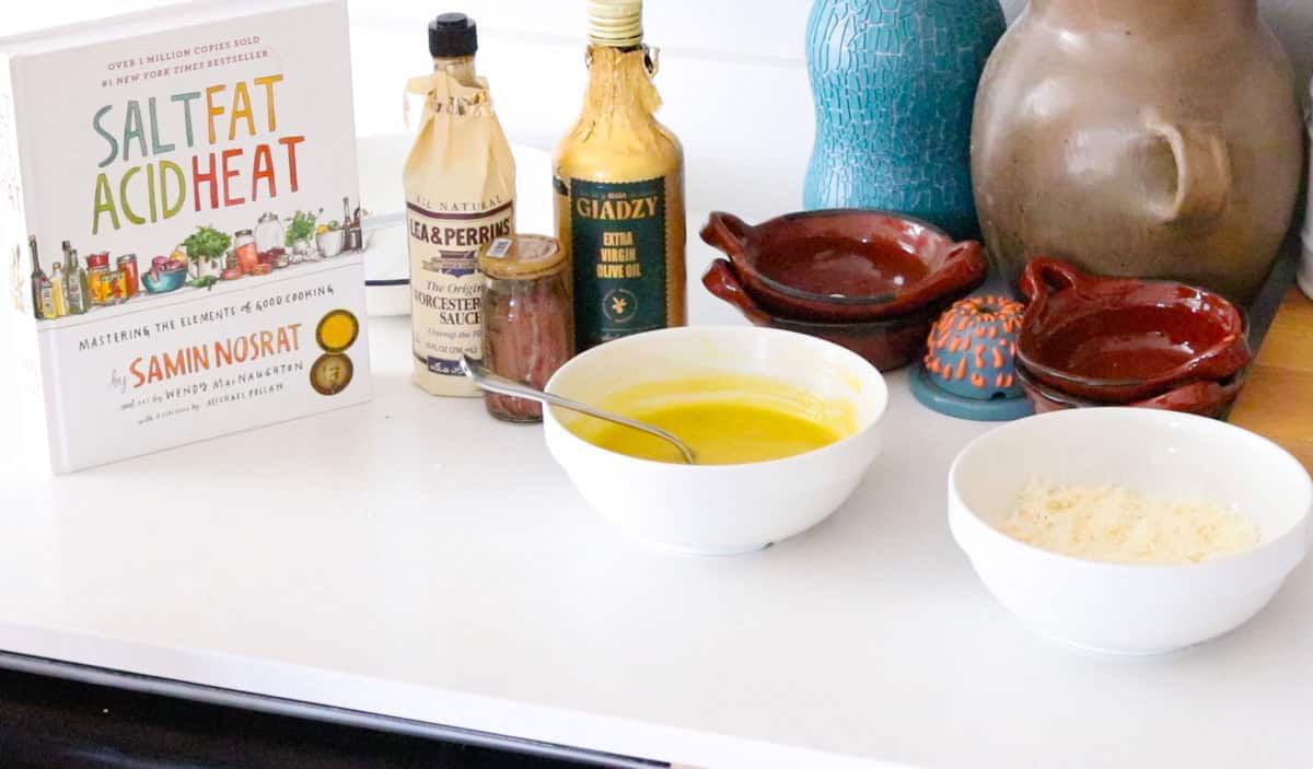 Salt, Fat, Acid, Heat beside caesar dressing and ingredients