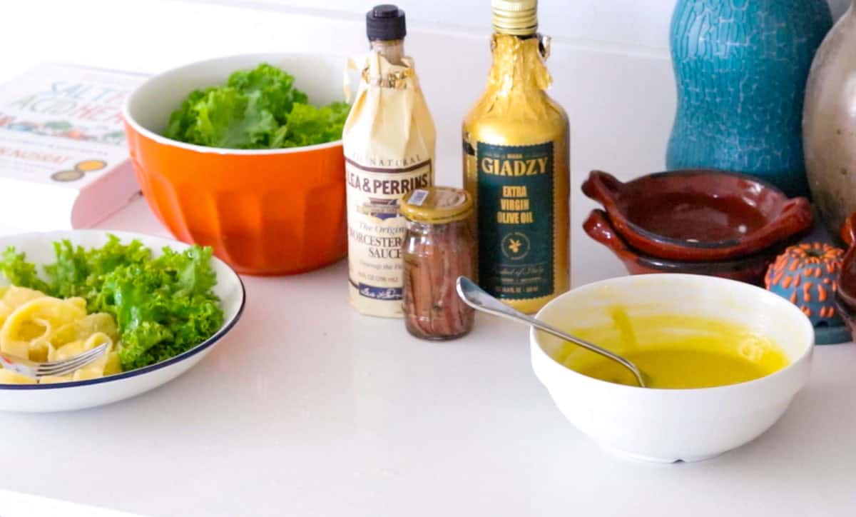 fettuccine alfredo and kale with caesar dressing beside ingredients