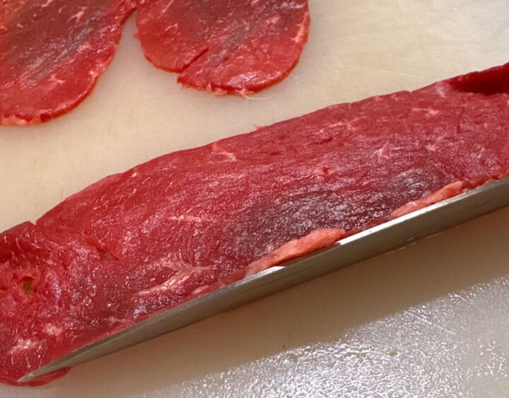 beef for braciole on a cutting board