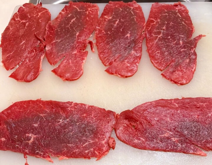 beef for braciole on a cutting board