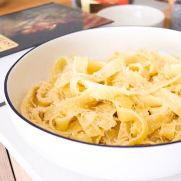 fettuccine alfredo in a serving bowl beside An Italian Feast