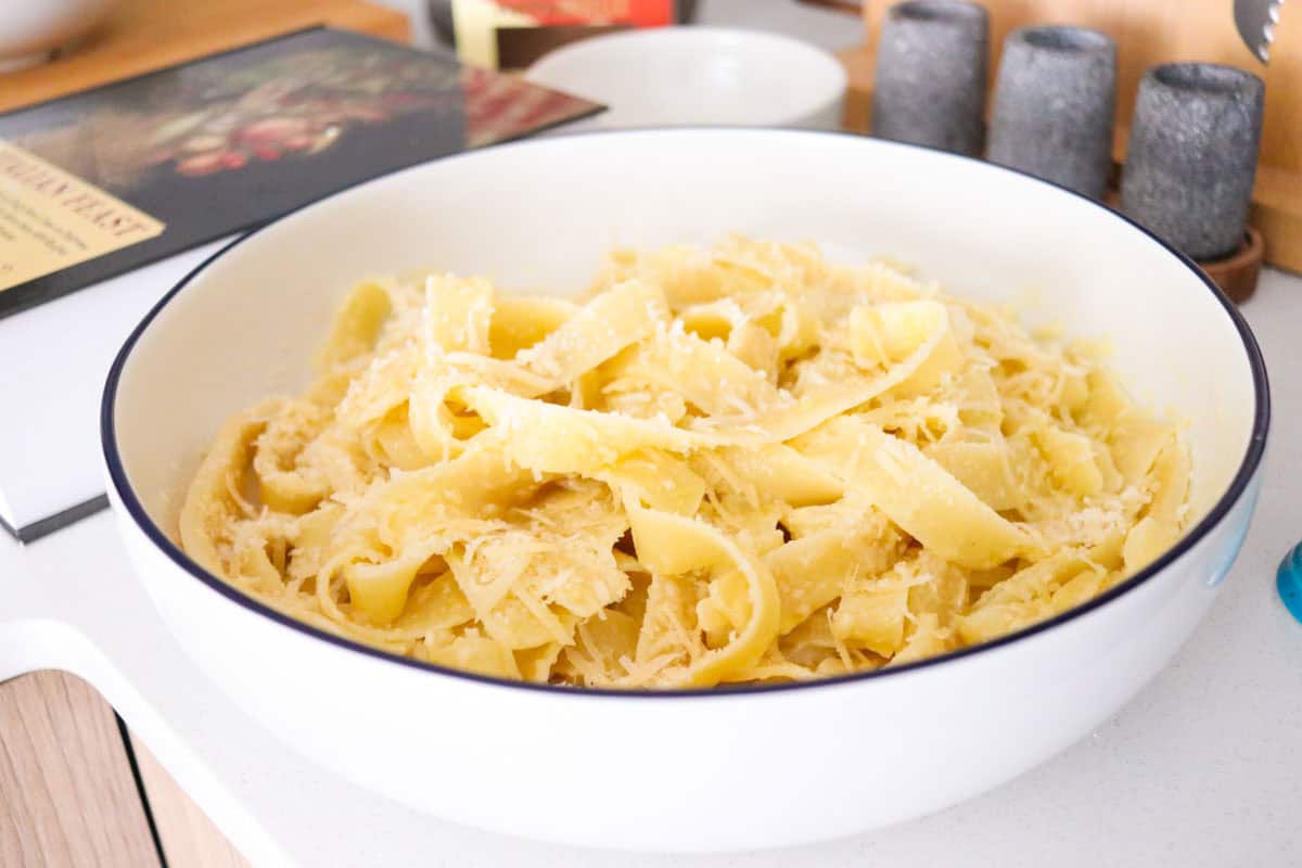 fettuccine alfredo in a serving bowl beside An Italian Feast