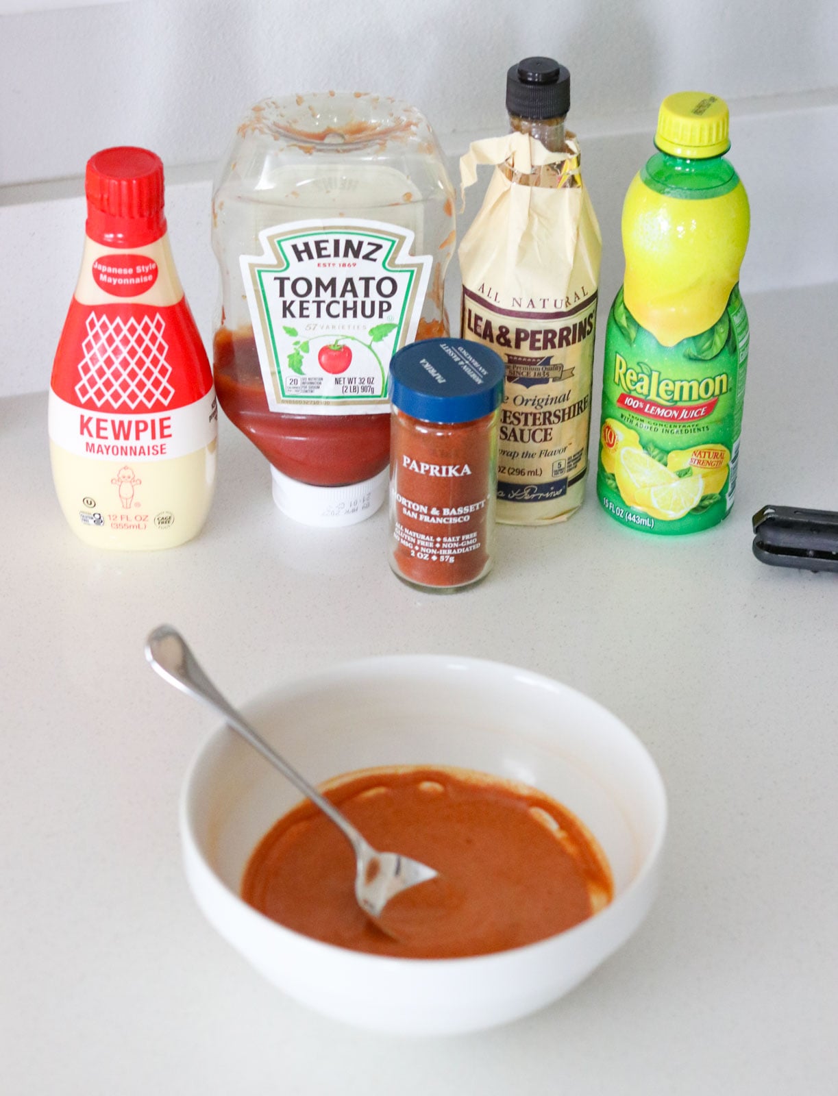 ingredients for making Marie Rose sauce and a bowl of it with a spoon