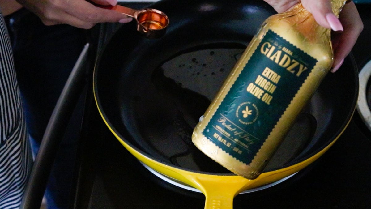 Giadzy extra-virgin olive oil over a Made In enameled cast iron pan