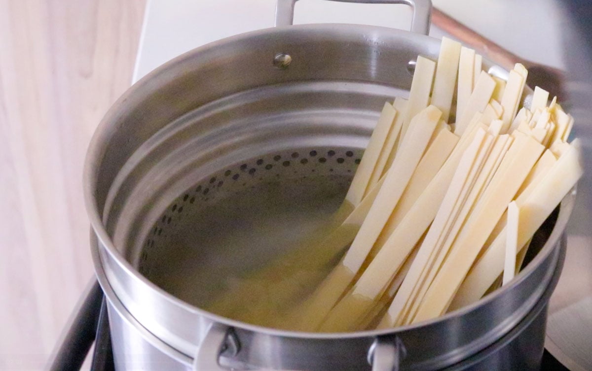 Giadzy pappardelle pasta in a Made In stock pot with a pasta insert