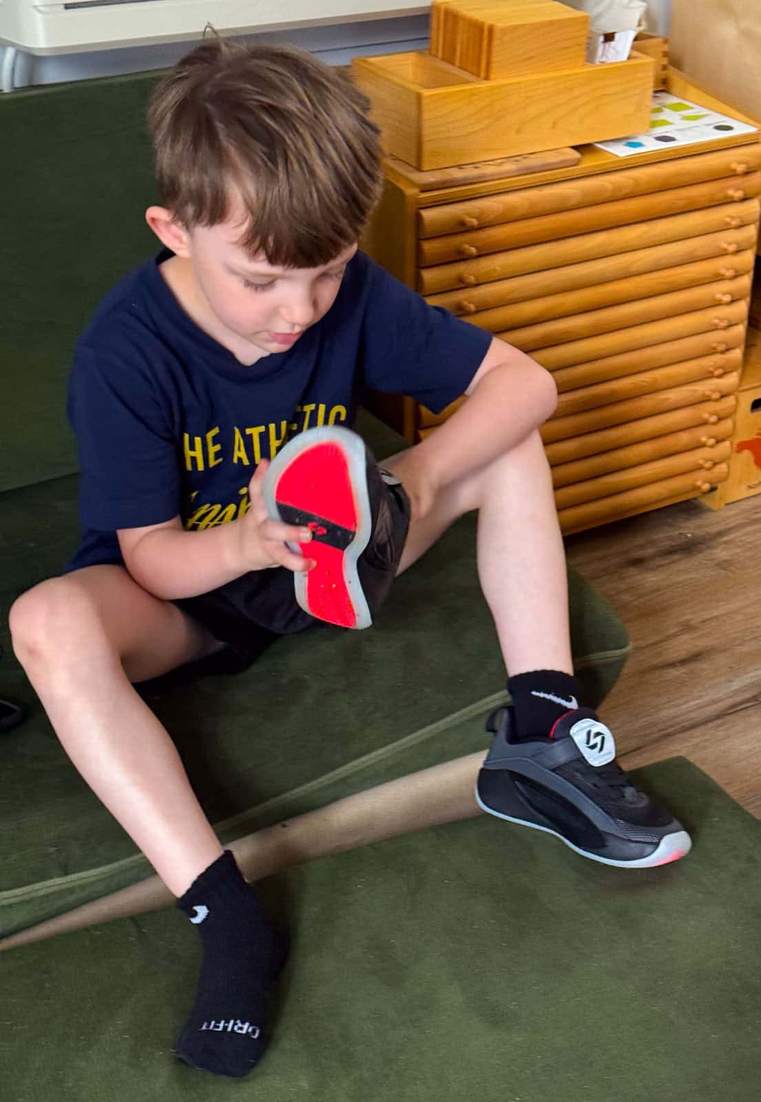 John is putting on his Jordan Luka 5 shoes for little kids