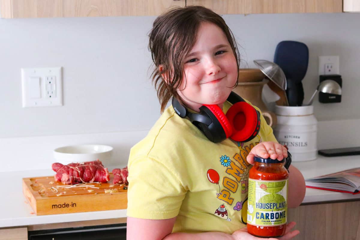 Kaia is holding Houseplant x Carbone marinara sauce
